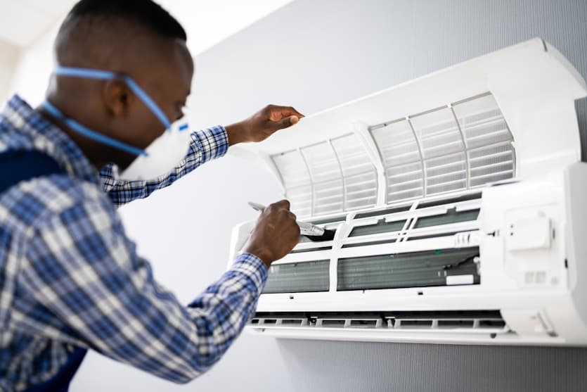 Technician servicing AC unit
